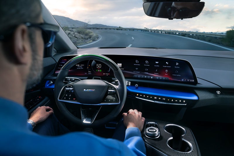 Front View of the 2026 OPTIQ-V Driving Through the Dusk Utilizing its Headlights | RJ Burne Cadillac in Scranton PA